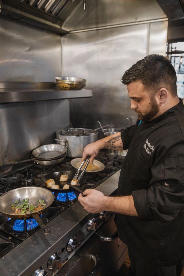 Chef Dan Luber prepares pan seared scallops at Center Square Tavern